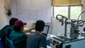 Engineering students discussing and solving the task given on the automation machine system in the laboratory Royalty Free Stock Photo