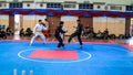 Two men athletes competes during the `Sukan Kombat 6 Penjuru` competition or fighting combat games.