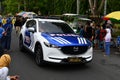 Bangkalan, East Java, Indonesia - October 25, 2022 : Indonesian police car cross the road at a carnival in Bangkalan, Indonesia