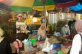 A woman is making Nasi Serpang to be served to customers. Nasi Serpang is a typical meal from Bangkalan, Madura, East Java