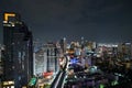 Bangkok city nightscape with Nana BTS Train Station and northbound Sukhumvit line in the foreground, Jul 2019