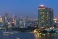 Bangkok cityscape. Bangkok river side with light of Yacht at twilight time. Royalty Free Stock Photo