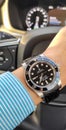 Rolex Submariner no date model on wrist in Volvo car