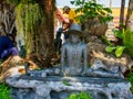 One of several small statues in the grounds of the Wat Pho Reclining Buddha Temple in Bangkok, Thailand Royalty Free Stock Photo