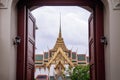 Bangkok Grand Palace `Dusit Maha Prasat` throne hall seen through gate Royalty Free Stock Photo