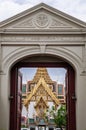 Bangkok Grand Palace `Dusit Maha Prasat` throne hall seen through main gate and alphabet on top of the gate is `Pratu Suwan Boriba Royalty Free Stock Photo