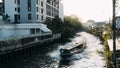 Bangkok khlong canal boat cruises through canal in downtown bangkok at sunset