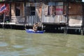 Bangkok Man in Boat padeling in front of House canal water river asian culture Royalty Free Stock Photo