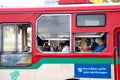 Bangkok people in medical masks on a city bus.