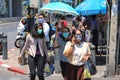 Bangkok people in medical masks walk through the city.
