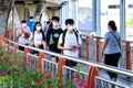 Bangkok people in medical masks walk through the city.