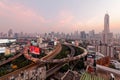 Bangkok at rosy dusk with skyscrapers in background and busy traffic on elevated expressways & circular interchanges Royalty Free Stock Photo