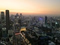 Bangkok skyline during sunset with skyscraper buildings in the front, and an orange red sky Royalty Free Stock Photo