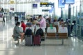 Bangkok Suvarnabhumi airport passengers sit waiting for their flight. Royalty Free Stock Photo