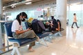 Bangkok Suvarnabhumi airport passengers sit waiting for their flight. Royalty Free Stock Photo
