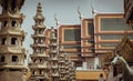 Architecture exterior of the chapel with Gable apex roof and Chinese stone sculptures against blue sky at the famous Wat Suthat Royalty Free Stock Photo