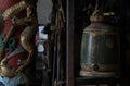 Sculptured golden dragons red pillar and Traditional old green iron bell hanging in Phutthamonthon sathan