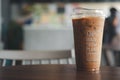 Bangkok, Thailand - April 26, 2020: Closeup of iced coffee cup in 100% made from plants at Inthanin coffee