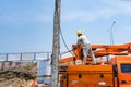 Bangkok, Thailand - April, 24, 2021 : Electricity workers are repairing power poles during the day in Thailand