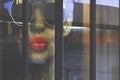 Fashion hipster woman face illustration on the wall inside of modern shop on walking street with blurred glass door on foreground Royalty Free Stock Photo