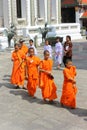 Bangkok, Thailand - April 29, 2014. Group of Asian monks walking through the temple of the Emerald Buddha in Thailand