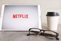 BANGKOK, THAILAND - April 28, 2018 : Netflix app on ipad tablet screen with eyeglasses and coffee during stay home Royalty Free Stock Photo