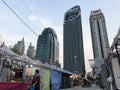 BANGKOK, THAILAND - APRIL 16, 2018: Old one story market meets huge skyscrapers - Concrete jungle