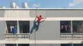 BANGKOK,THAILAND-APRIL 11, 2020:Outdoor painter Painting a tall building in Bangkok, Thailand