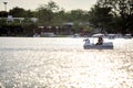 People ride duck boat at public park name Suan Luang Rama IX on sunset time Bangkok, Thailan