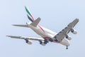 Plane or aircraft of Emirates Airlines or Airways on the sky landing to Suvanabhumi airport.