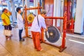 The ritual of beating traditional gong in City Pillar Shrine, Bangkok, Thailand