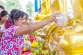 BANGKOK THAILAND - April 16, 2018: Songkran Festival, Woman use the water pouring to golden buddha statue. Songkran Festival is he Royalty Free Stock Photo