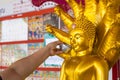 Bangkok, Thailand - April, 11, 2021 : Thai people sprinkle water on the Buddha statue on Songkran Day to worship and make wishes