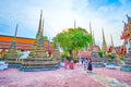 Tourists walk in Wat Pho temple in Bangkok, Thailand