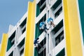 Painter climbing the building to painted at wall