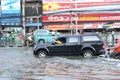 Bangkok, Thailand - April 11 2011 : woman take photo at her mobile phone while sitting outside car in flood events hits ladprao I