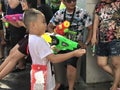 Bangkok, Thailand - April 13 2019 : Young Asian boy playing water gun splash in Songkran festival Royalty Free Stock Photo