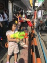 Bangkok, Thailand - April 13 2019 : Young Asian girl playing water gun splash in Songkran festival Royalty Free Stock Photo