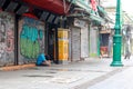 Young man sitting and head down in front of the closed shop on Khaosan road.