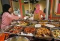 Asian female vendors selling street food, meat dishes, seafood for hungry customers