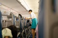 BANGKOK, THAILAND - Aug 27, 2018 - Bangkok Airways flight attendant serve food and drinks to passengers on board. Royalty Free Stock Photo