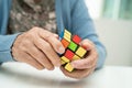 Bangkok, Thailand August 14, 2023 Alzheimer disease AD, Asian elderly woman patient playing Rubik cube game to practice brain