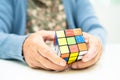 Bangkok, Thailand August 14, 2023 Alzheimer disease AD, Asian elderly woman patient playing Rubik cube game to practice brain