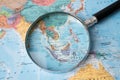 Bangkok, Thailand - August 01, 2020 Asia, Magnifying glass close up with colorful world map