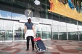 BANGKOK, THAILAND - AUGUST 8, 2017: Asian woman dragging luggage suitcase walking in Suvarnabhumi Airport. Suvarnabhumi Airport is Royalty Free Stock Photo