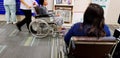 Asian woman sitting on wheel chair in hospital and waiting to see doctor