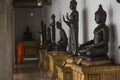 Bangkok, Thailand - 30 August 2020: black buddha statues with golden pedestal orderly row are arranging indoor