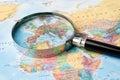 Europe, Magnifying glass close up with colorful world map