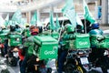 Bangkok, Thailand - August 24, 2020 : Group of Grab riders riding a bike doing their services. Grab is a multinational