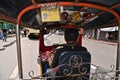 Bangkok Thailand. Inside taxi auto rickshaw Tuk Tuk with driver in traffic with cars and motorcycles on streets of